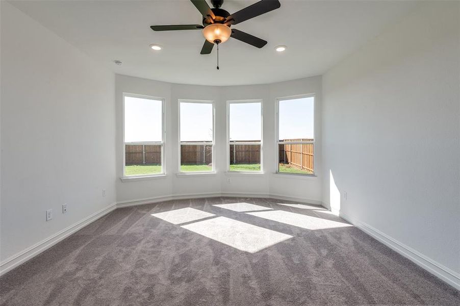 Unfurnished room with carpet and ceiling fan