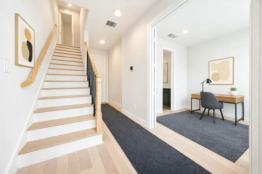 Gorgeous light-colored wood floors in the entryway. Virtual staging added.