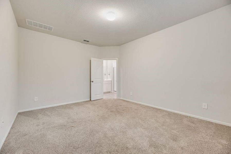 Carpeted room with light-toned walls and an angled architectural detail