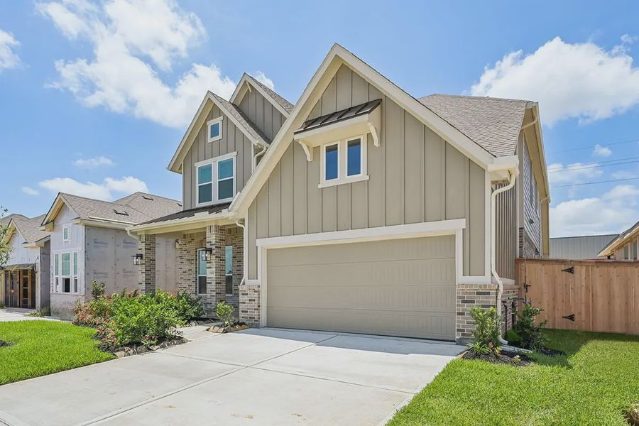 Front exterior of a new home in Wood Leaf Reserve, Tomball, TX, highlighting curb appeal (Image 2). Front exterior of a new home in Wood Leaf Reserve, Tomball, TX, highlighting curb appeal (Image 2).