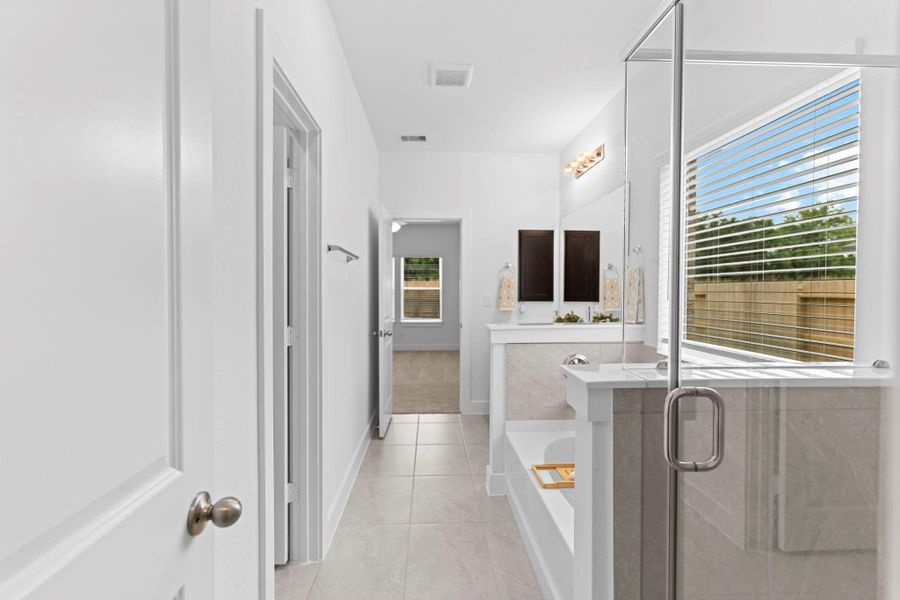 View from the primary closet through the bathroom shows off the open layout, connecting all the elements of your private retreat seamlessly. **Image Representative of Plan Only and May Vary as Built**.