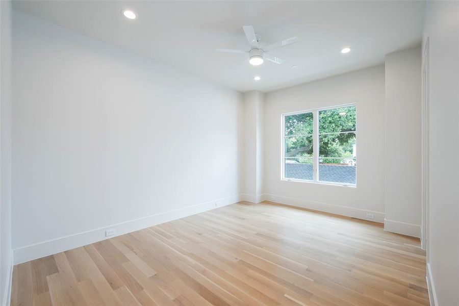 Spare room with ceiling fan and light hardwood / wood-style flooring