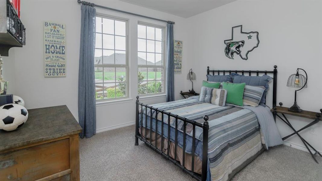 Bright room featuring two large windows overlooking a green landscape