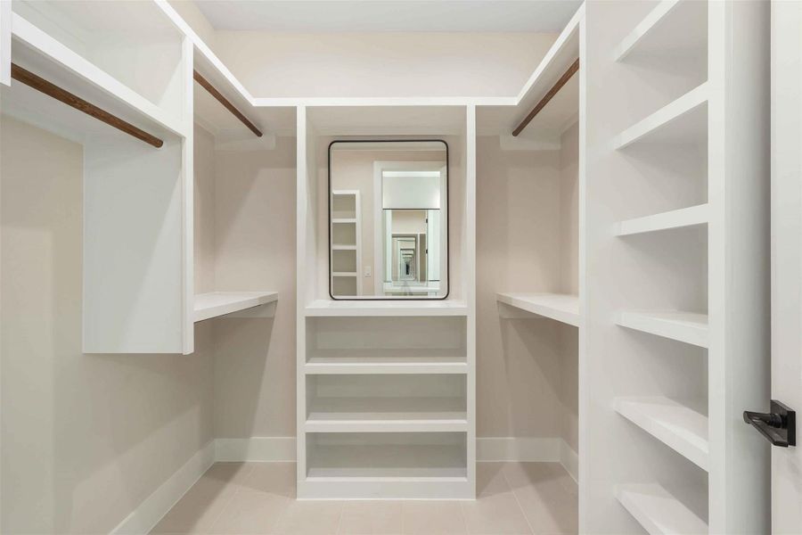 Walk in closet with tile patterned flooring Walk in closet with tile patterned flooring