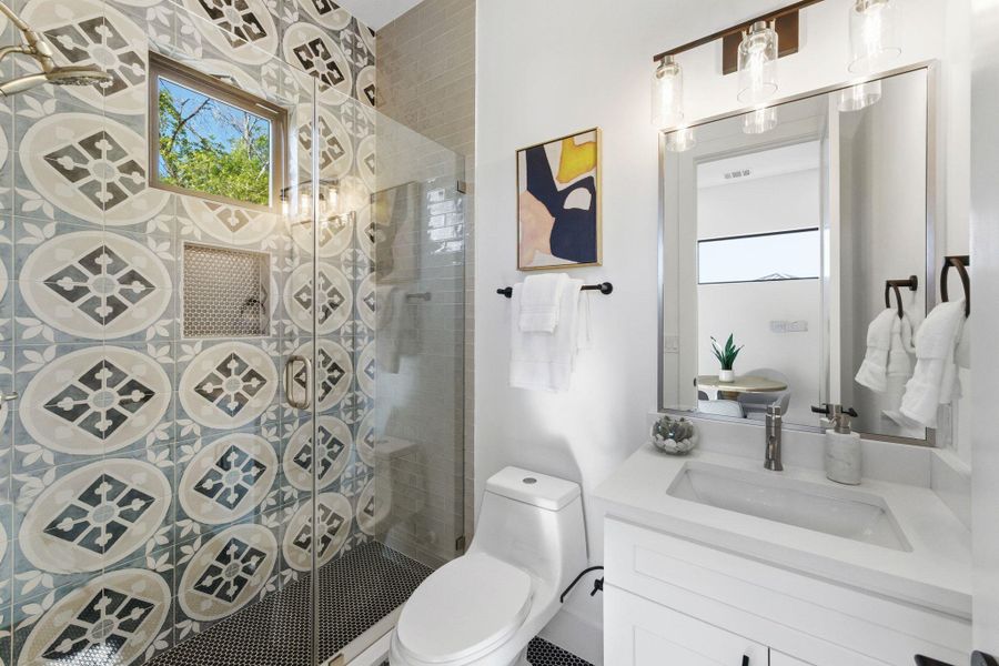 Bathroom featuring vanity and a shower stall Bathroom featuring vanity and a shower stall