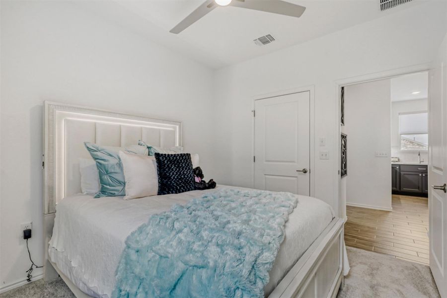 Bedroom featuring ceiling fan and light carpet