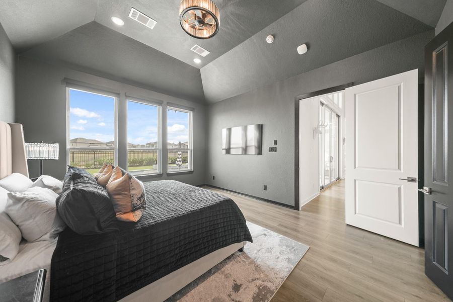 With room for a sitting area, the owner's suite showcases the views of the back through three windows with remote controlled roller shades.