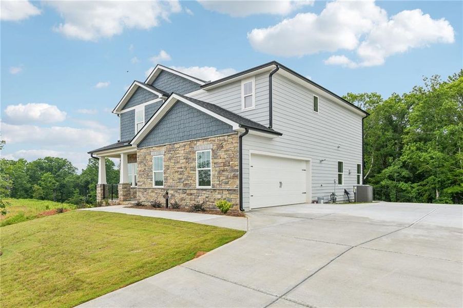 Front exterior of a new home in River Pointe, Monroe, GA, highlighting curb appeal (Image 2). Front exterior of a new home in River Pointe, Monroe, GA, highlighting curb appeal (Image 2).