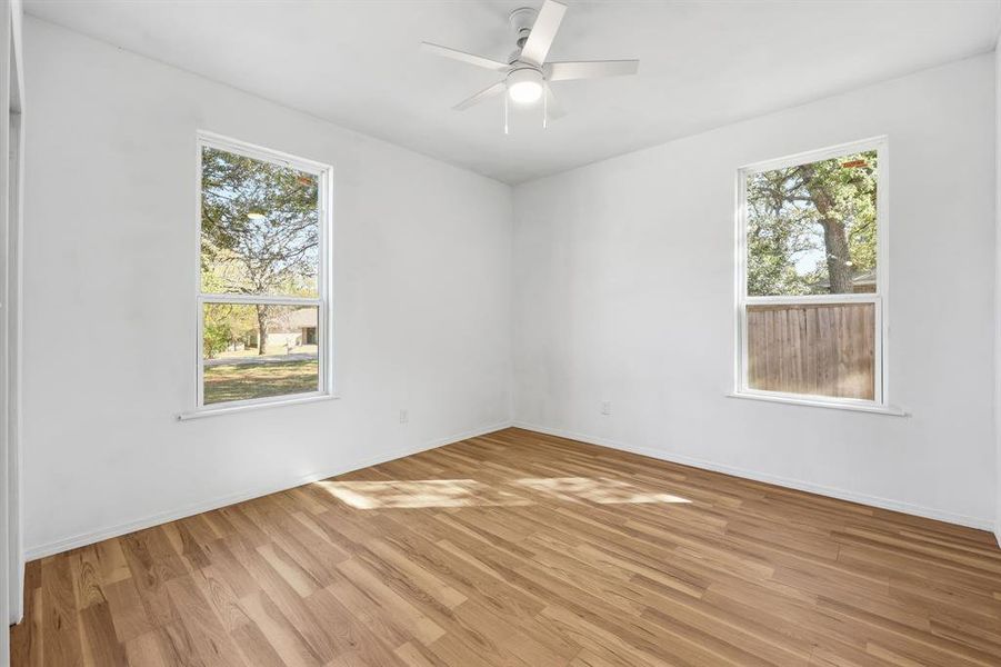 Bedroom 2 featuring light wood-style floors and a ceiling fan