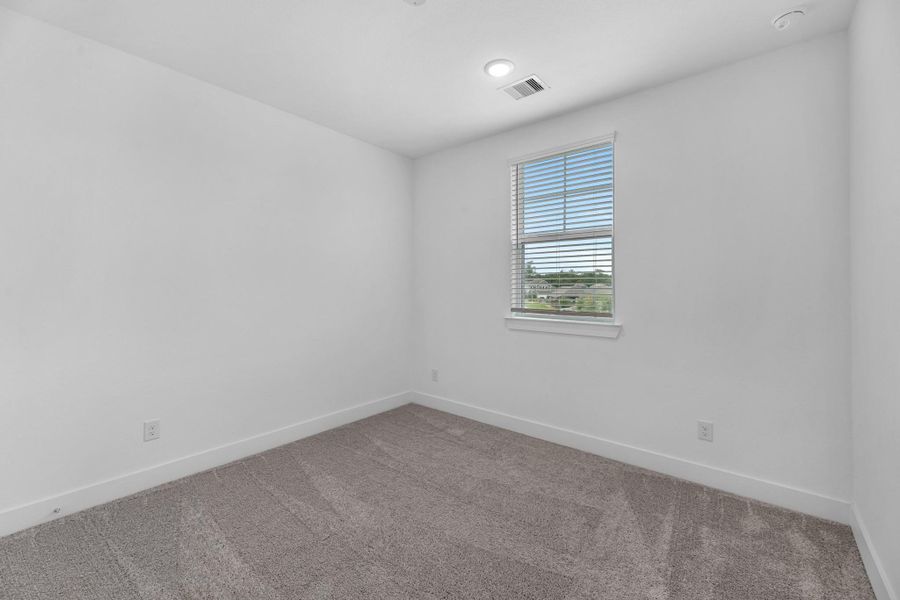 Another comfortable secondary bedroom with soft carpet flooring and peaceful ambiance, ready to fit any lifestyle need.