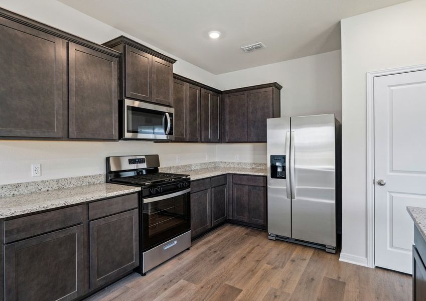 The kitchen has sprawling granite countertops.