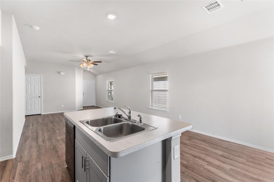 Kitchen with double sink overlooking living area. Kitchen with double sink overlooking living area.