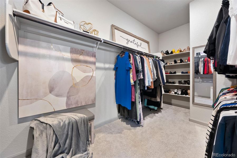 Lovely & large primary closet with high ceilings.