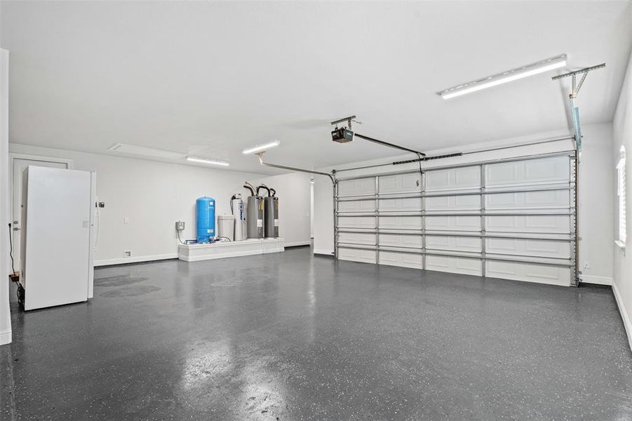 Garage featuring water heater, and a garage door opener Garage featuring water heater, and a garage door opener