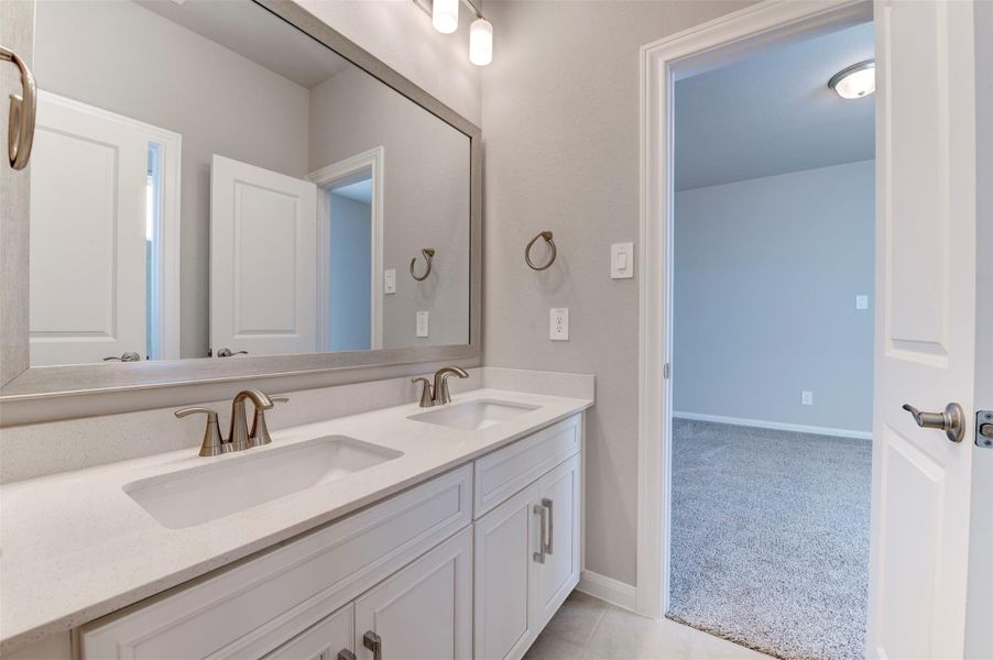 Shared secondary bathroom with modern vanity and convenient access for two bedrooms.