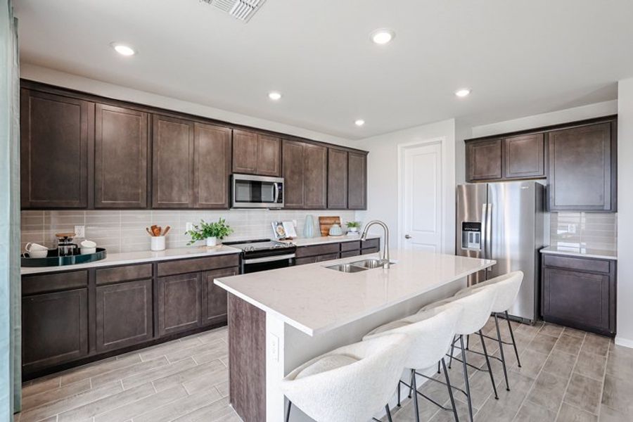 A kitchen with a table and chairs. A kitchen with a table and chairs.