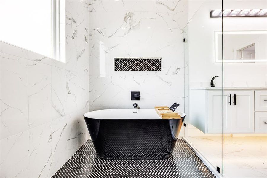 Bathroom featuring a freestanding bath and vanity Bathroom featuring a freestanding bath and vanity