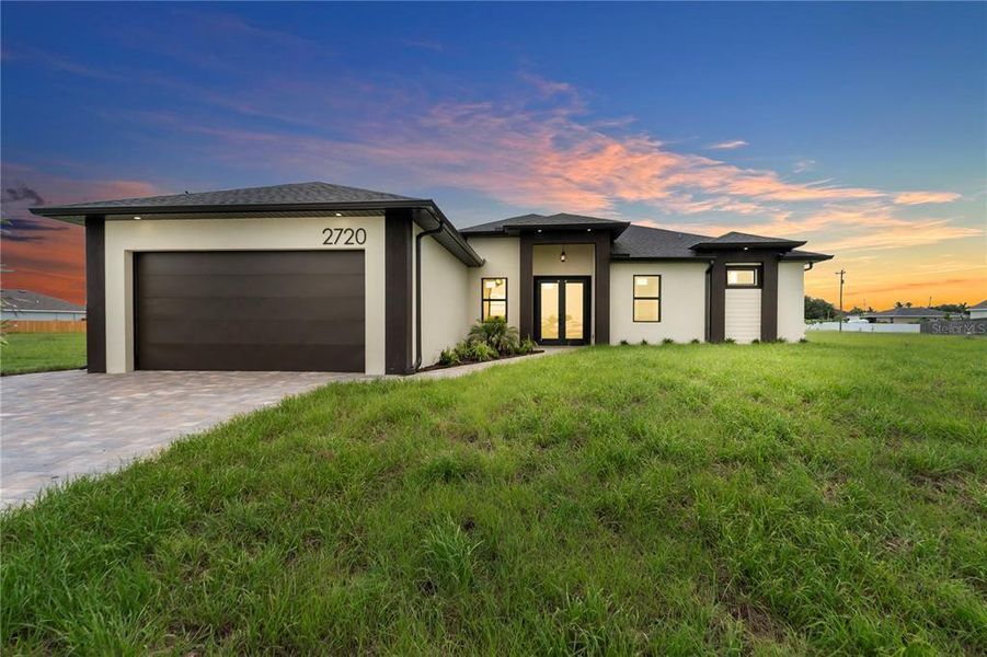 Front exterior of a new home in , Cape Coral, FL, highlighting curb appeal (Image 1). Front exterior of a new home in , Cape Coral, FL, highlighting curb appeal (Image 1).