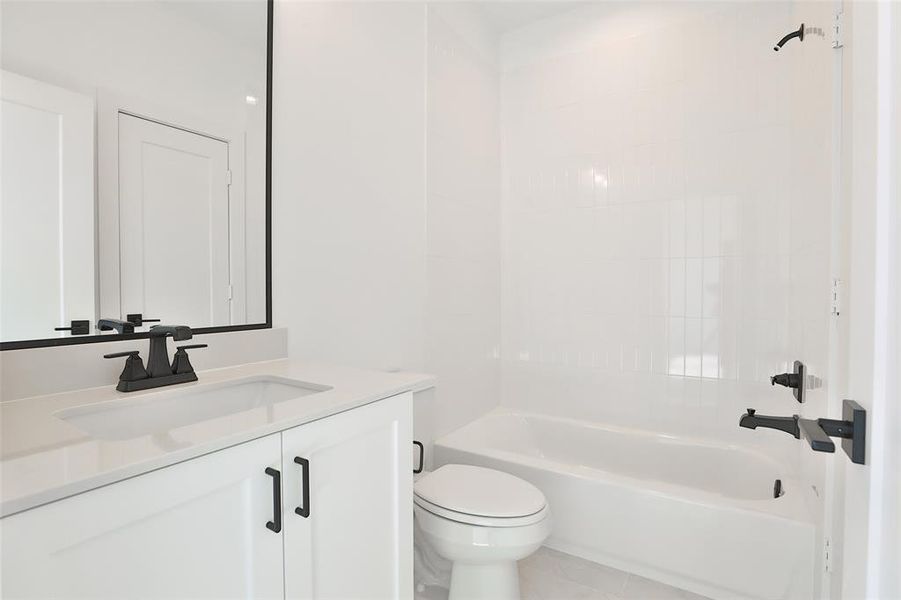 The third full bathroom features a shower/tub combination, with sleek black accents that enhance its modern design.