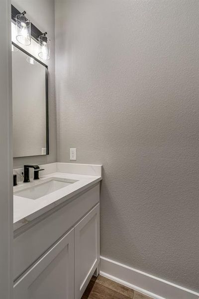 Bathroom with hardwood / wood-style flooring and vanity