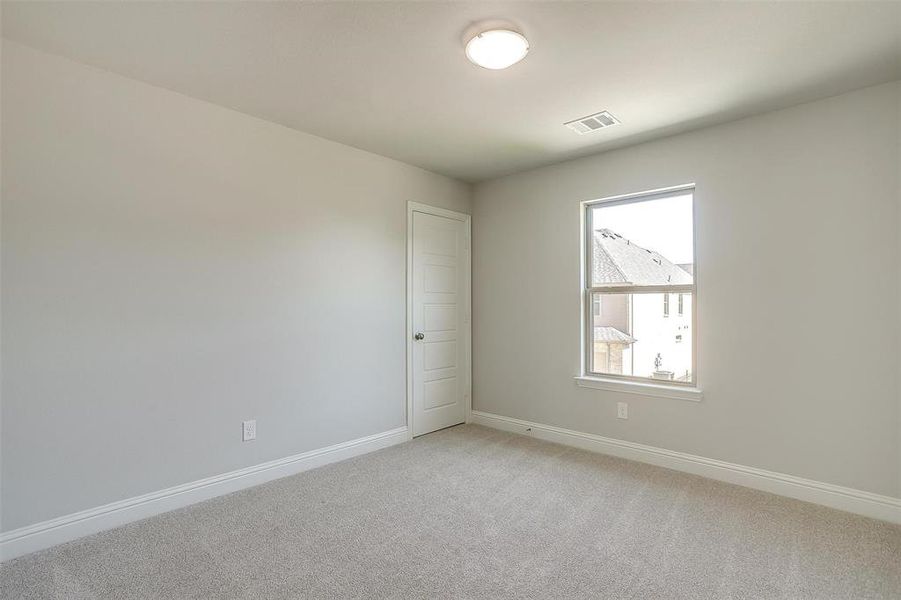 Unfurnished room featuring light colored carpet and baseboards Unfurnished room featuring light colored carpet and baseboards