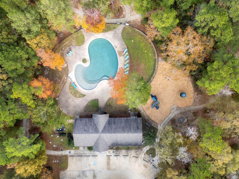Aerial view of the pool, club house, and park.