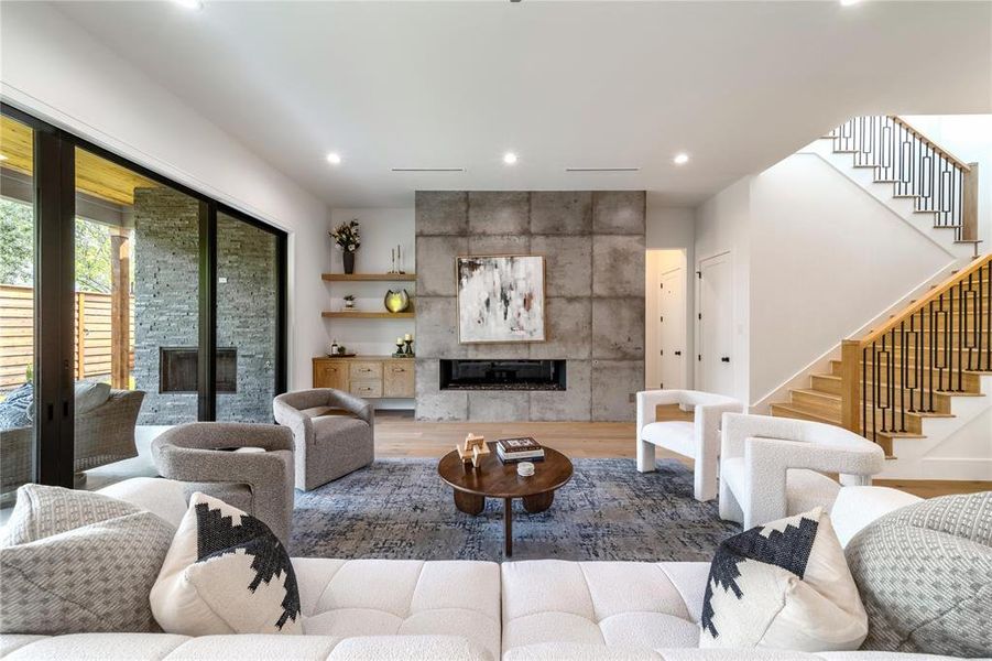 Living area featuring a fireplace, wood finished floors, and recessed lighting