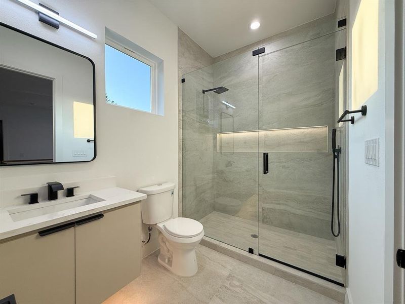 Full bathroom featuring vanity and a marble finish shower