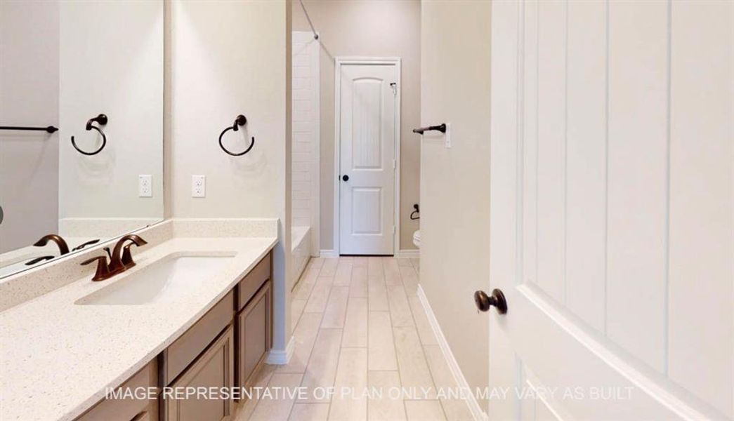 Full bathroom with vanity, light wood finished floors, and bathtub / shower combination Full bathroom with vanity, light wood finished floors, and bathtub / shower combination