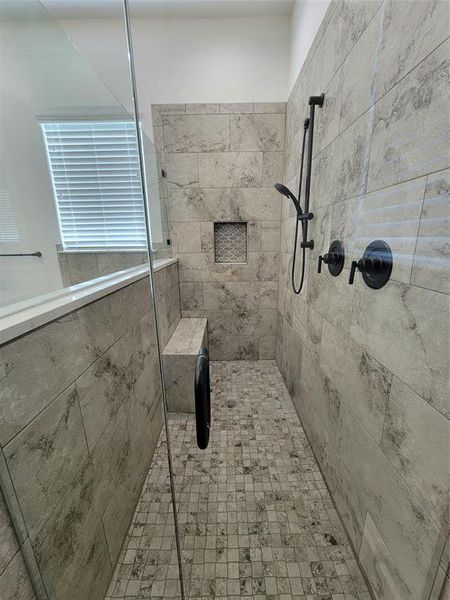 Bathroom with tiled shower