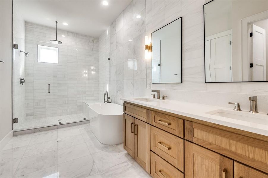 Full bathroom with a shower stall, double vanity, a soaking tub, tile walls, and recessed lighting