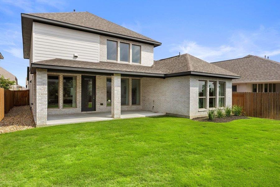 A private backyard oasis with ample green space and a covered patio for outdoor enjoyment.