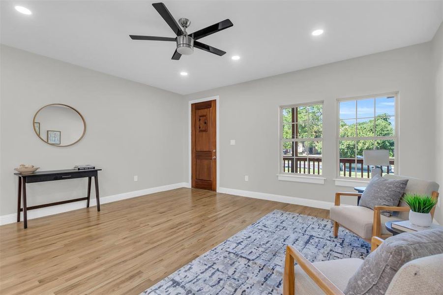 Sitting room with recessed lighting, light wood-type flooring, and a ceiling fan
