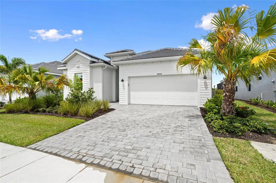 Front exterior of a new home in Webbs Reserve, Punta Gorda, FL, highlighting curb appeal (Image 2). Front exterior of a new home in Webbs Reserve, Punta Gorda, FL, highlighting curb appeal (Image 2).