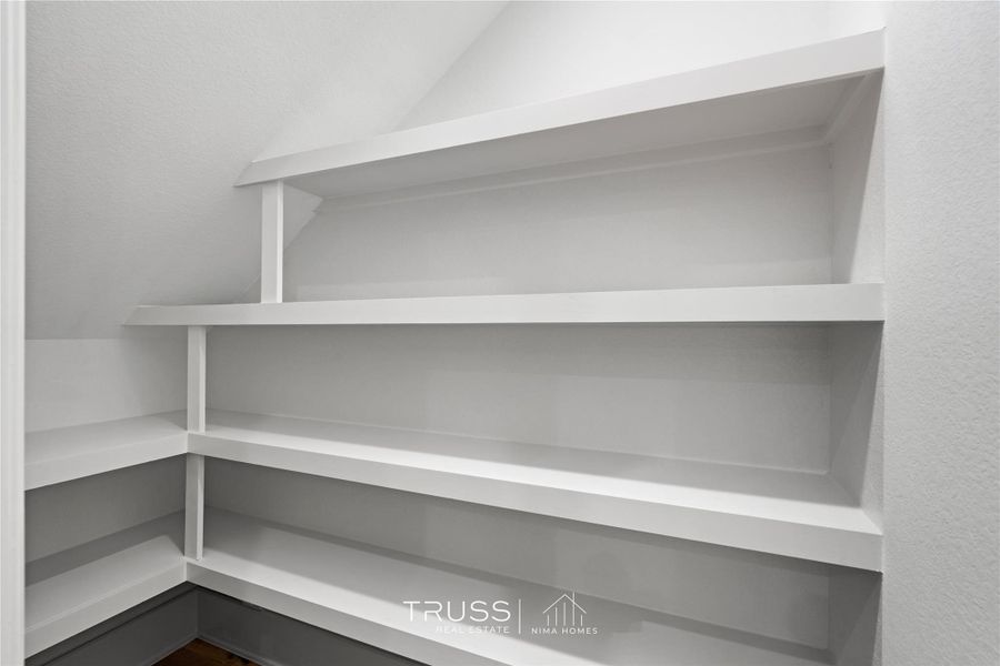 Thoughtfully designed built-in shelving maximizes every inch of space, offering practical, well-lit storage that keeps the home’s clean, modern aesthetic consistent throughout