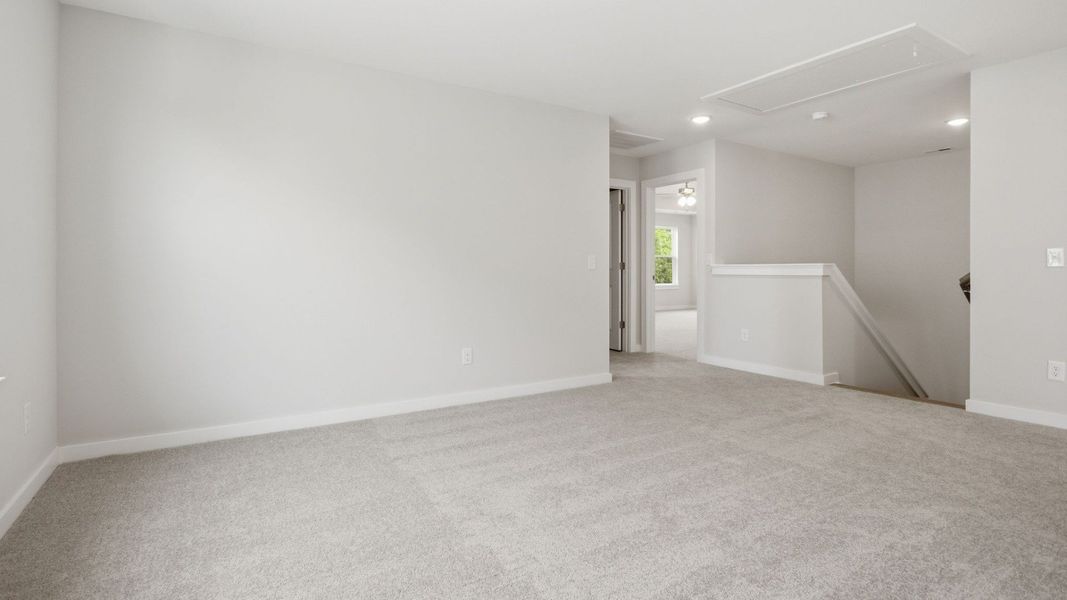 Second Floor Loft area with view of stairs, access to dedicated laundry room, and access to primary suite Second Floor Loft area with view of stairs, access to dedicated laundry room, and access to primary suite