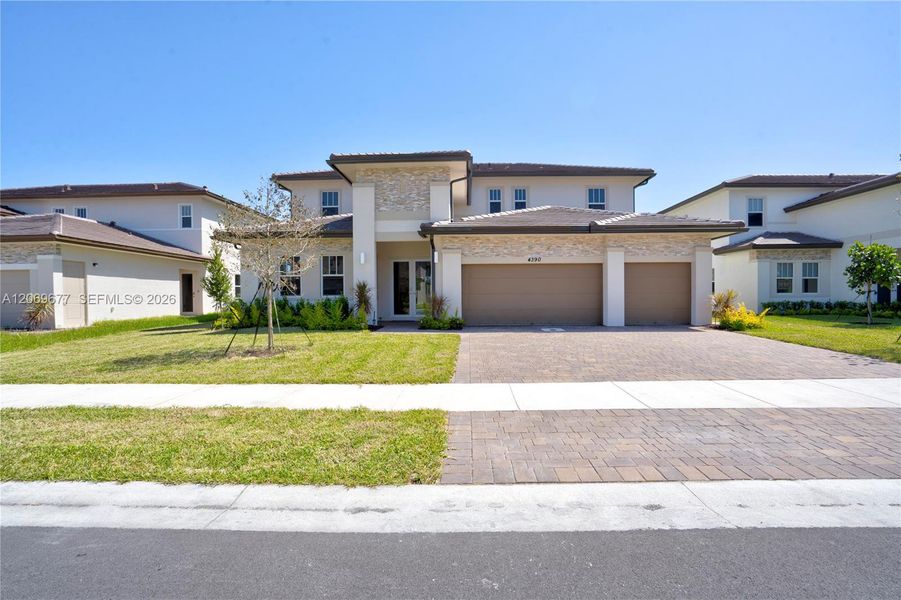 Front exterior of a new home in , Davie, FL, highlighting curb appeal (Image 2). Front exterior of a new home in , Davie, FL, highlighting curb appeal (Image 2).