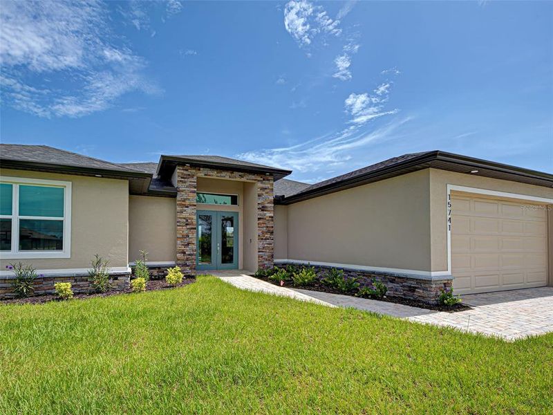 Front exterior of a new home in , Port Charlotte, FL, highlighting curb appeal (Image 15).