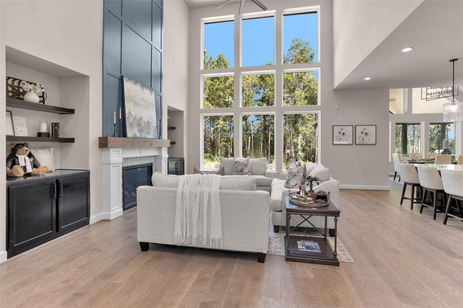 A dramatic wall of windowsfloods the space with naturallight, while custom built-ins flankthe fireplace for added charmand storage.