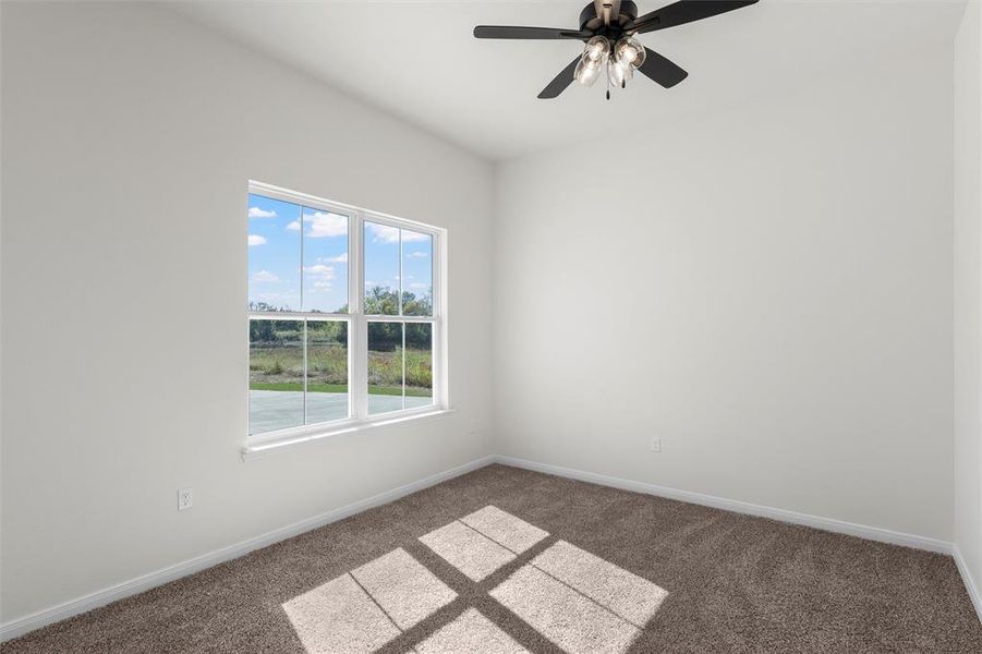 Spare room with carpet floors and ceiling fan