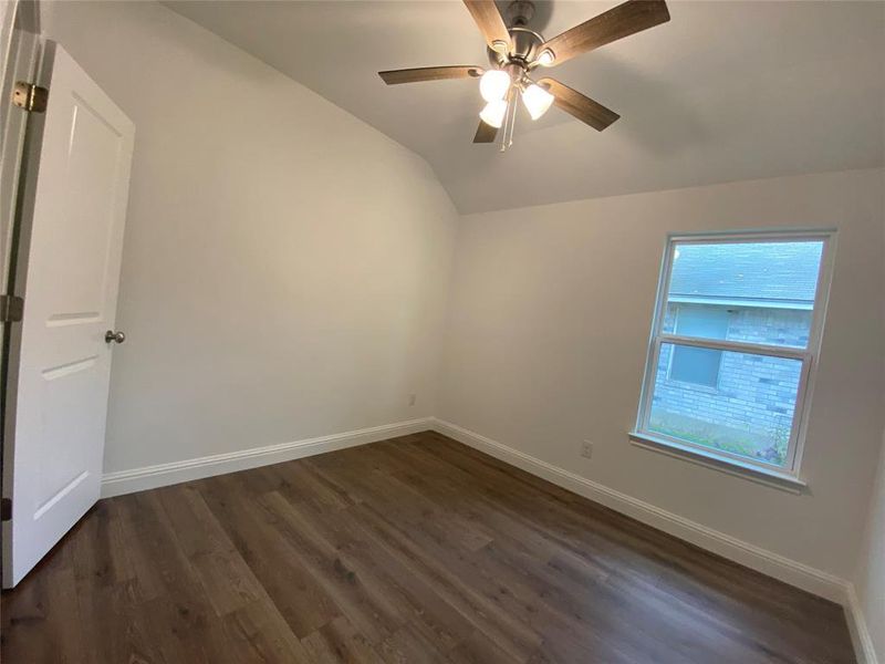 Lofted ceiling, dark wood-type flooring, and ceiling fan Lofted ceiling, dark wood-type flooring, and ceiling fan