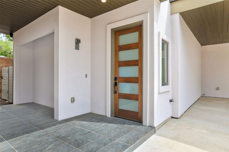 Property entrance featuring stucco siding Property entrance featuring stucco siding