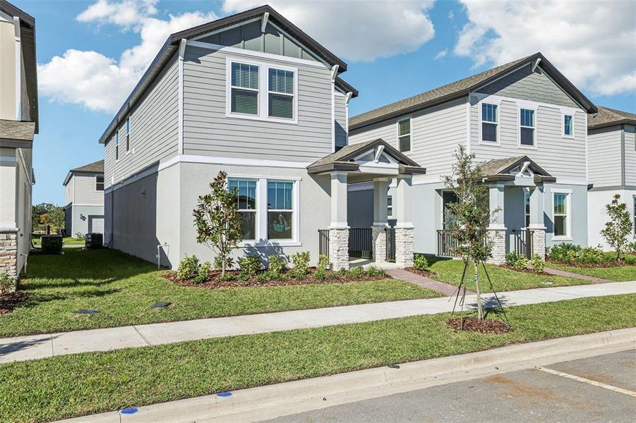 Front exterior of a new home in The Meadow at Crossprairie Bungalows, St. Cloud, FL, highlighting curb appeal (Image 19).
