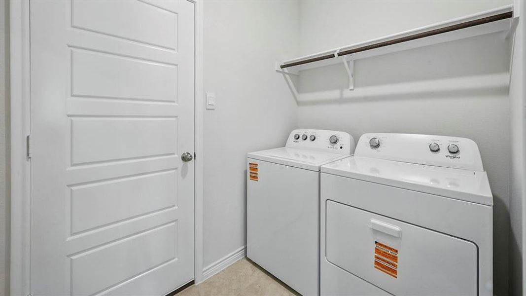 Laundry room with separate washer and dryer and baseboards Laundry room with separate washer and dryer and baseboards