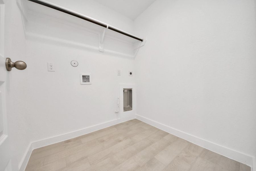 A perfect blend of functionality and comfort. Capture the essence of easy living with a first-floor laundry room, thoughtfully equipped with shelving for effortless organization. Both electric and gas connections available.