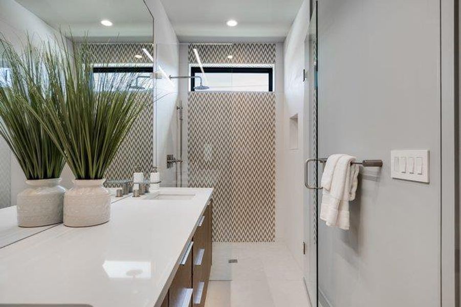 Owners ensuite with double vanity and oversized mirror.