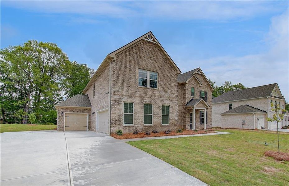 Front exterior of a new home in Cambria at Traditions, Hampton, GA, highlighting curb appeal (Image 22).