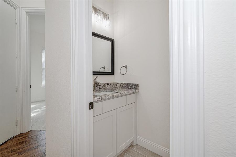 Bathroom featuring hardwood / wood-style floors and vanity