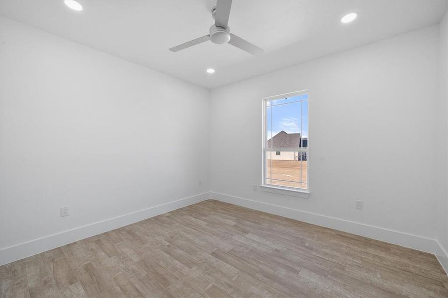 Unfurnished room with light wood-type flooring and ceiling fan