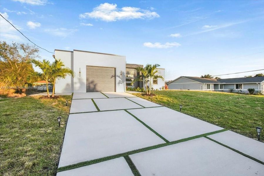 Front exterior of a new home in , Lehigh Acres, FL, highlighting curb appeal (Image 22).